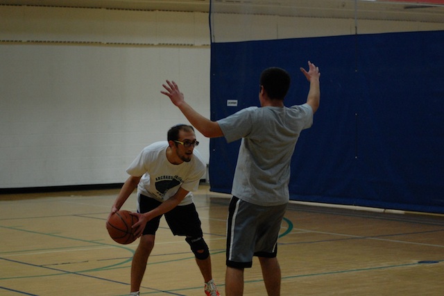 Fake out: Senior Oren Shapiro surveys the floor before he beats his opponent as he attempts to drive to the hoop during practice Jan. 28 at the Jewish Community Center.