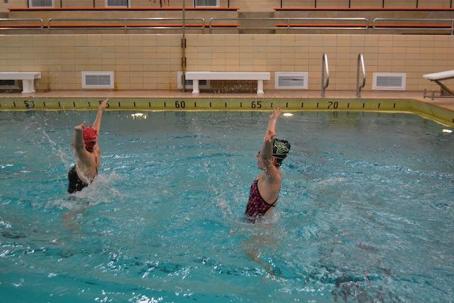 Juniors Hannah McDonell and Rose Evensen practice their synchronized swimming duet.