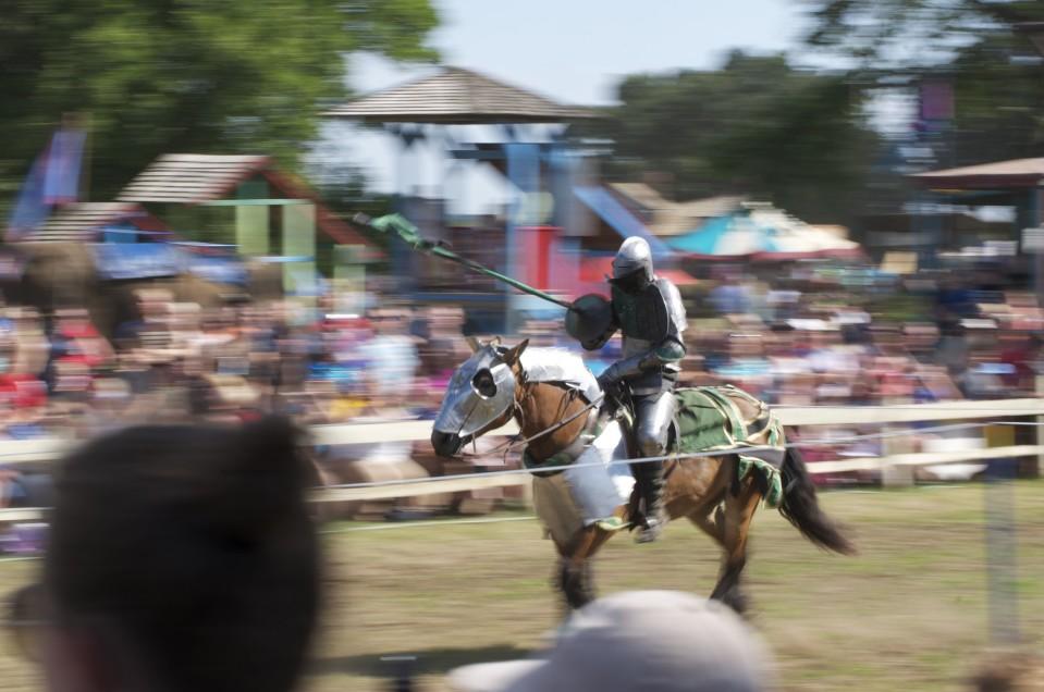 The Green Knight rides towards his opponent during a jousting match Aug. 17. In addition to the jousting competition, the knights competed in a sword fight on the ground.