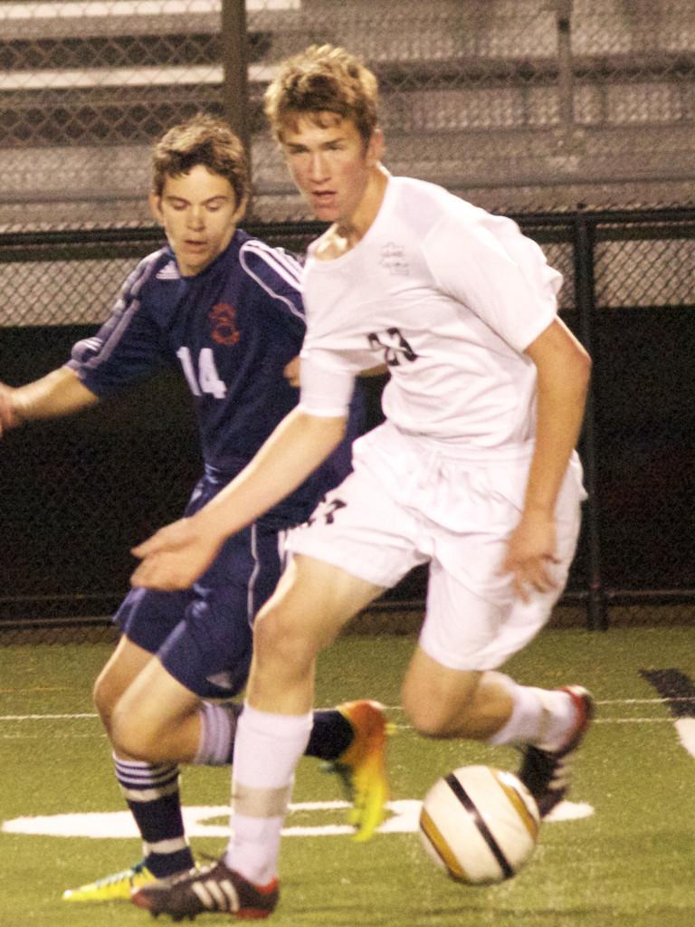 Sophomore Max Kent dribbles the ball away from a player during Parks first section game against Cooper Oct. 10. They won 6-0.
