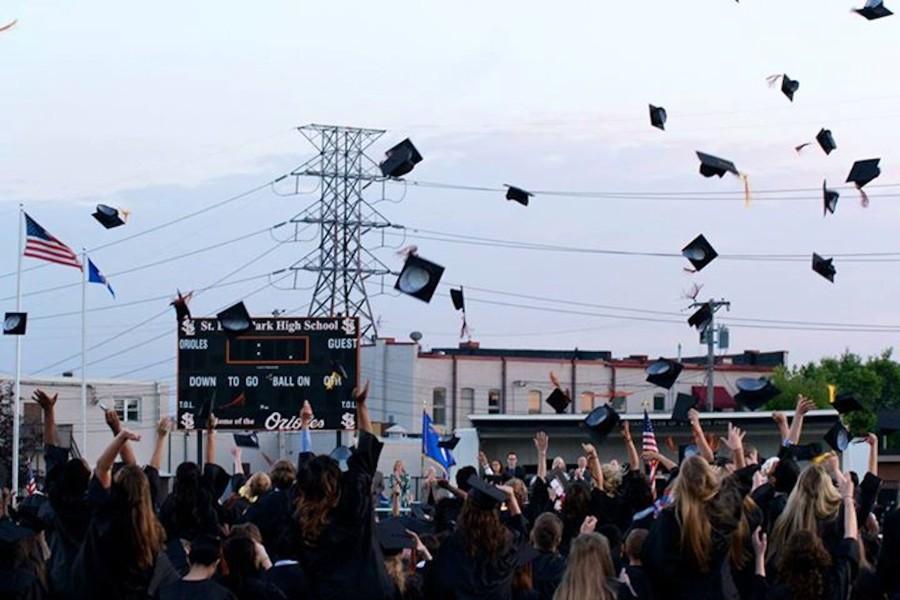 Seniors throw their caps into the air as the graduation ceremony comes to a close.