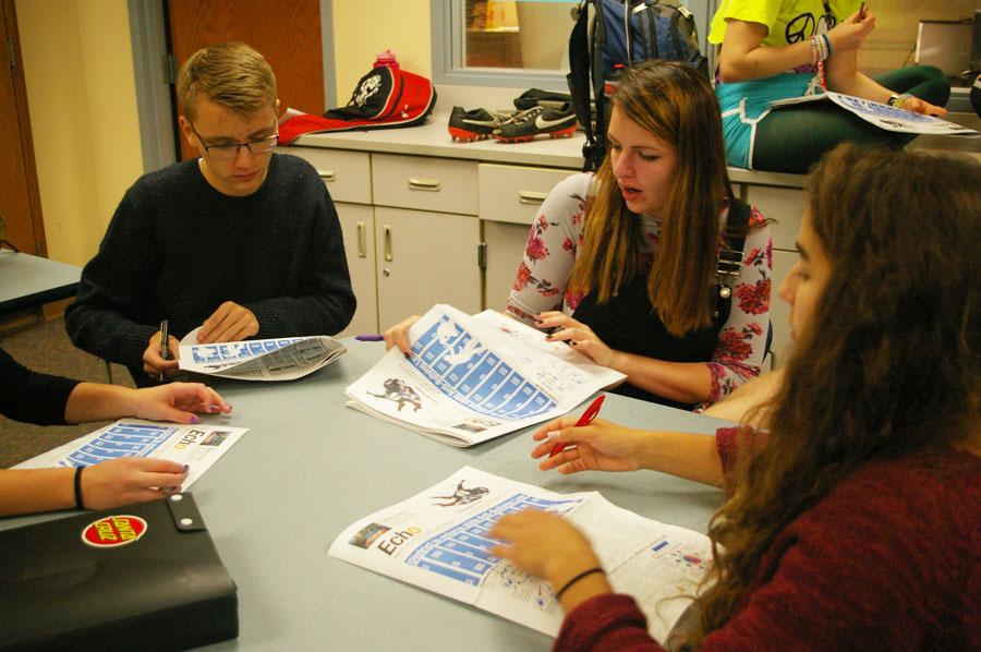 Echo staff members collaborate while editing a past issue.
