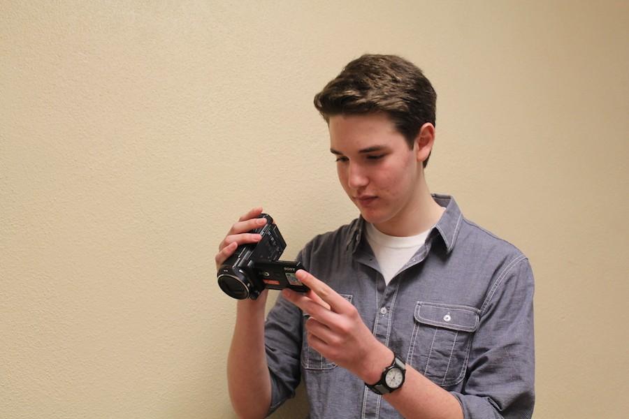 Camera ready: Junior Charlie Berg looks over his most recent film, a hobby he has pursued in his free time. He spends part of his weekends editing his films and being a part-time filmmaker.