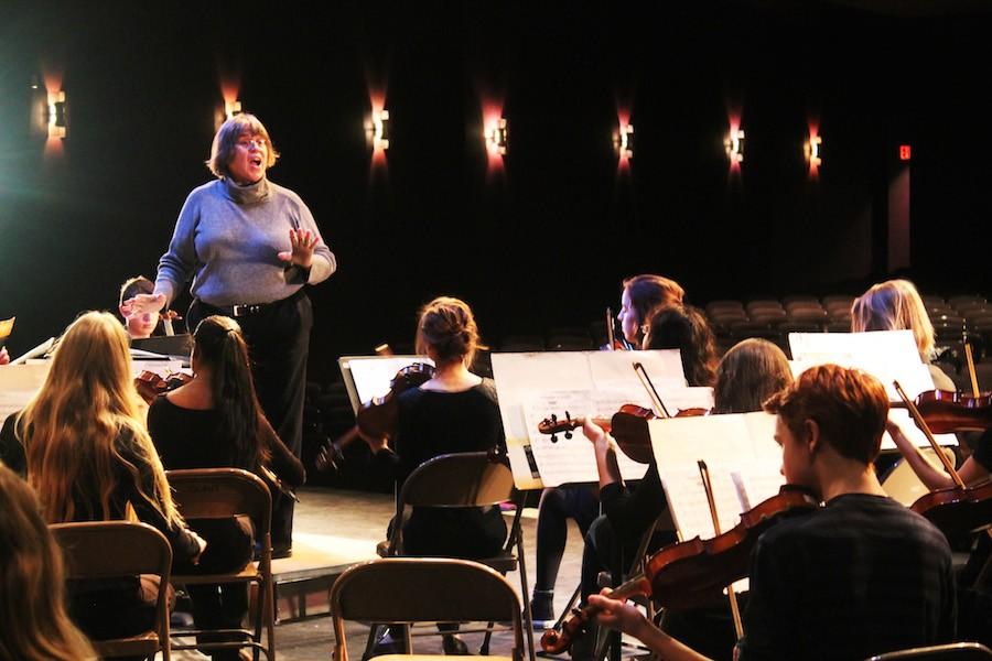 Elizabeth Barnes gives the orchestra constructive criticism to improve their piece. 