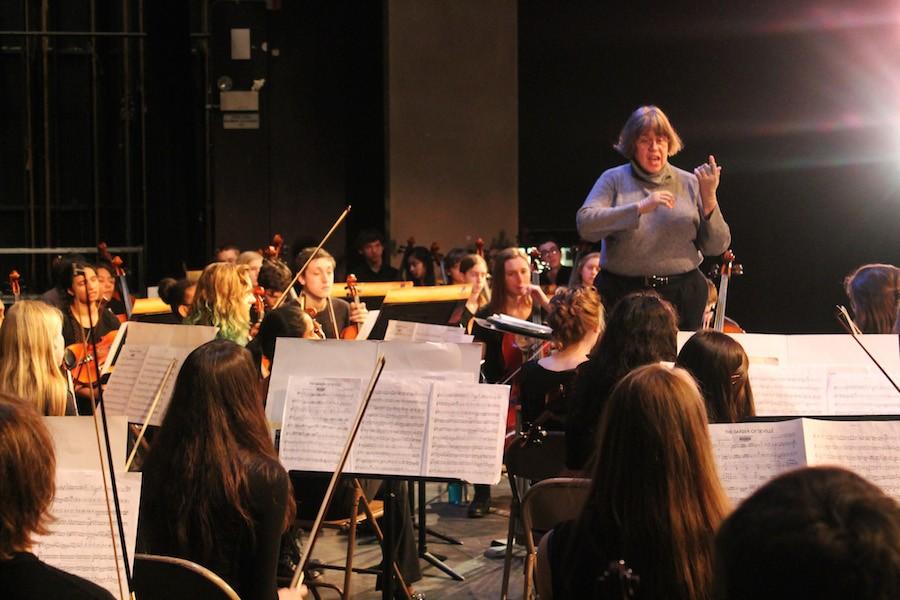 Guest conductor directs the orchestra during the West Metro Conference Orchestra Festival.