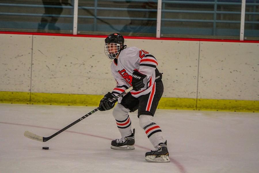 Protect the puck: Freshman Riley Dvorak eyes the ice during their home game victory against North Shore. The team looks to continue to win as sections approach.
