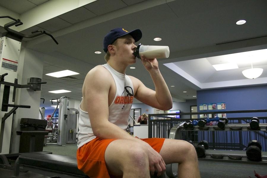 Junior Alex Crary drinks a protein shake after his workout, one of these shakes contains around 50 grams of protein.