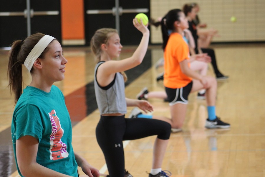 Juniors Mackenzie Evenson and Clara Slade line up to pass the ball as a warm-up at practice March 26.