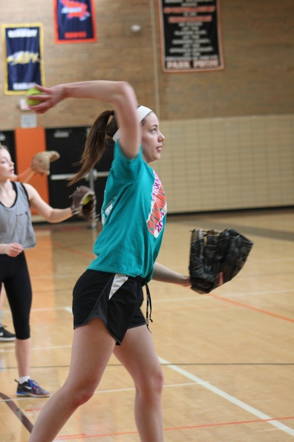 Junior Mackenzie Evenson focuses on her target as she throws the ball to her partner at practice March 26.