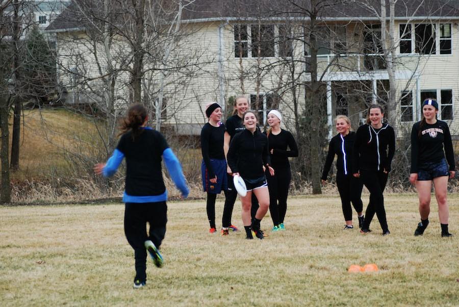 Team cooperation: Members of the girls’ ultimate team participate in drills together during a practice April 8. The girls normally practice in the field next to the track.