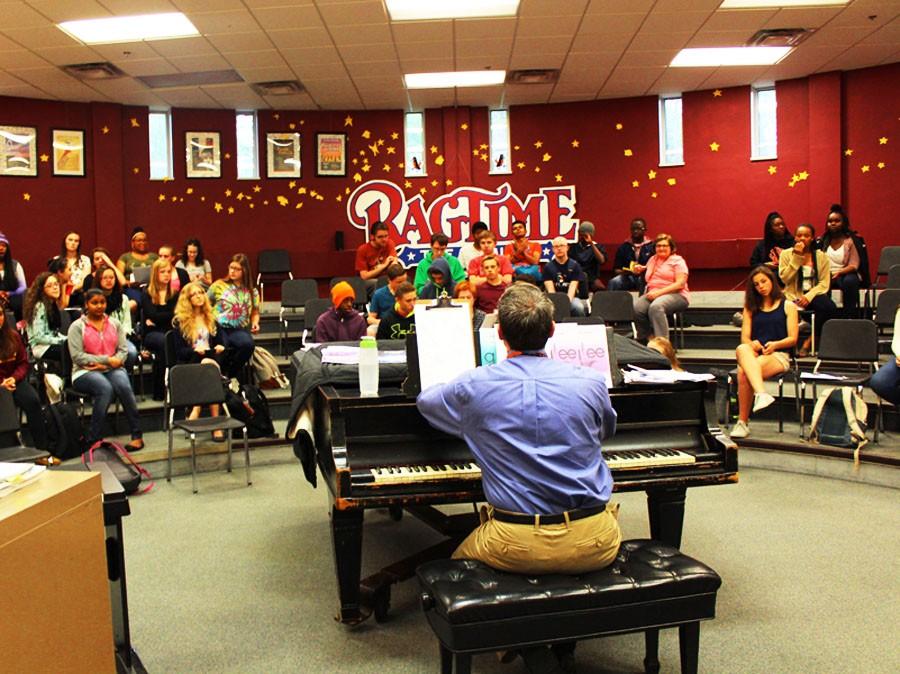 Mr. Myszkowski begins playing the piano as his choir class begins to sing another song. 