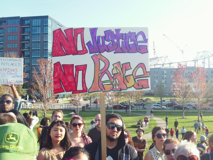Allies join together during a rally April 30 to celebrate black culture and lives. They carried signs saying windows can be replaced but lives cannot in response to the violent protests in Baltimore.
