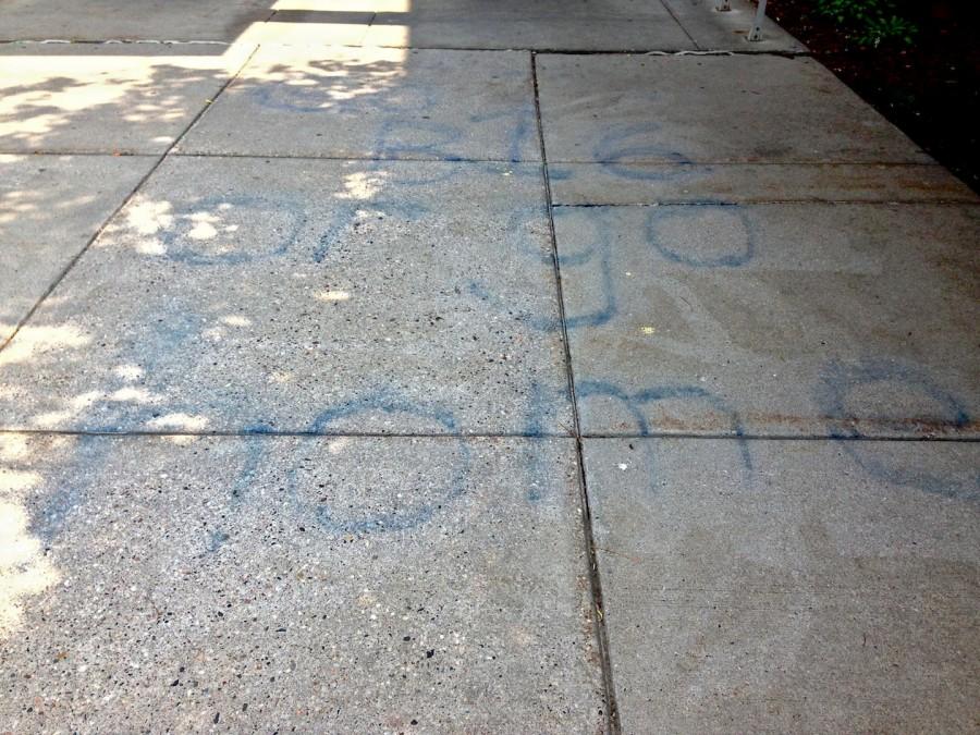 Despite the custodians attempts to remove it, the slogan is still visible on the cement outside the circle doors four days after the spray painting. The vandalism occurred June 4 while rising seniors painted the senior wall.