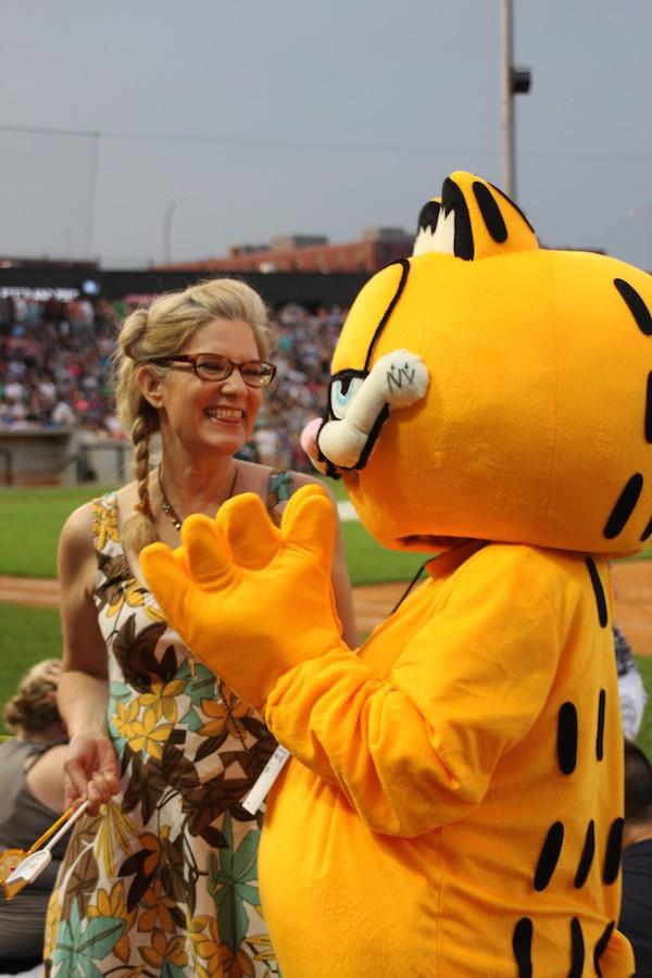 A woman smiles in preparation to take a picture with Garfield the cat at the Internet Cat Video Festival Aug. 12.