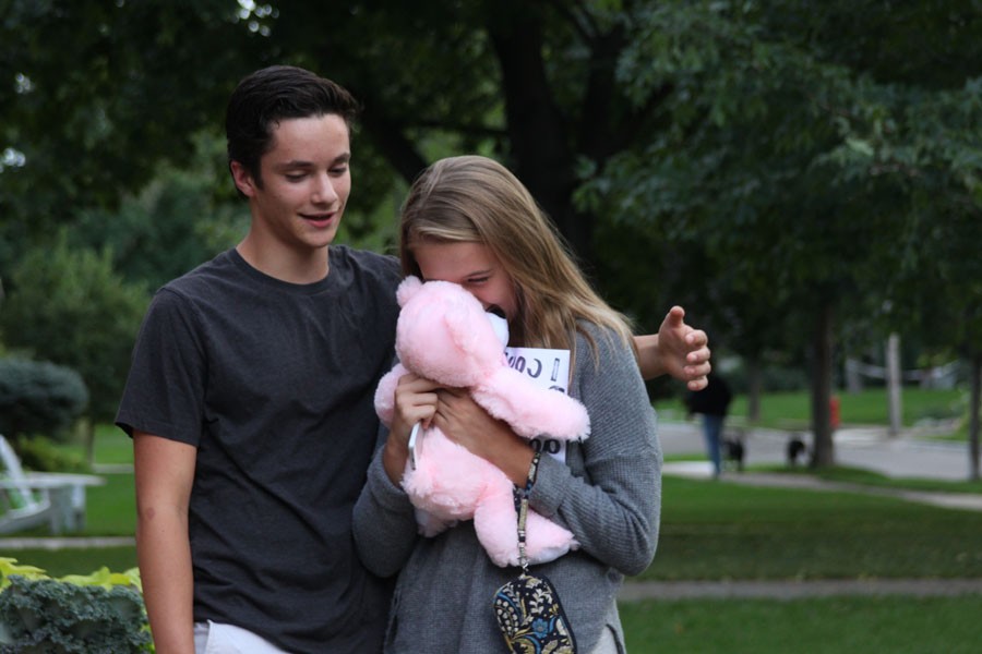 Sophomore Lillie Albright hugs her bear, sophomore David Salamzadeh gave her while asking her to Homecoming.