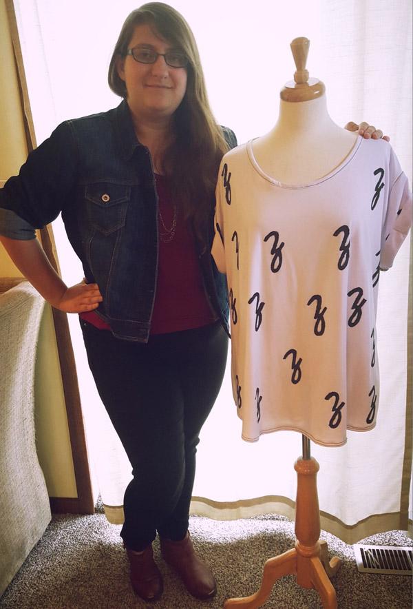 Sophomore Zoe Weinmann poses next to a shirt she designed and created.