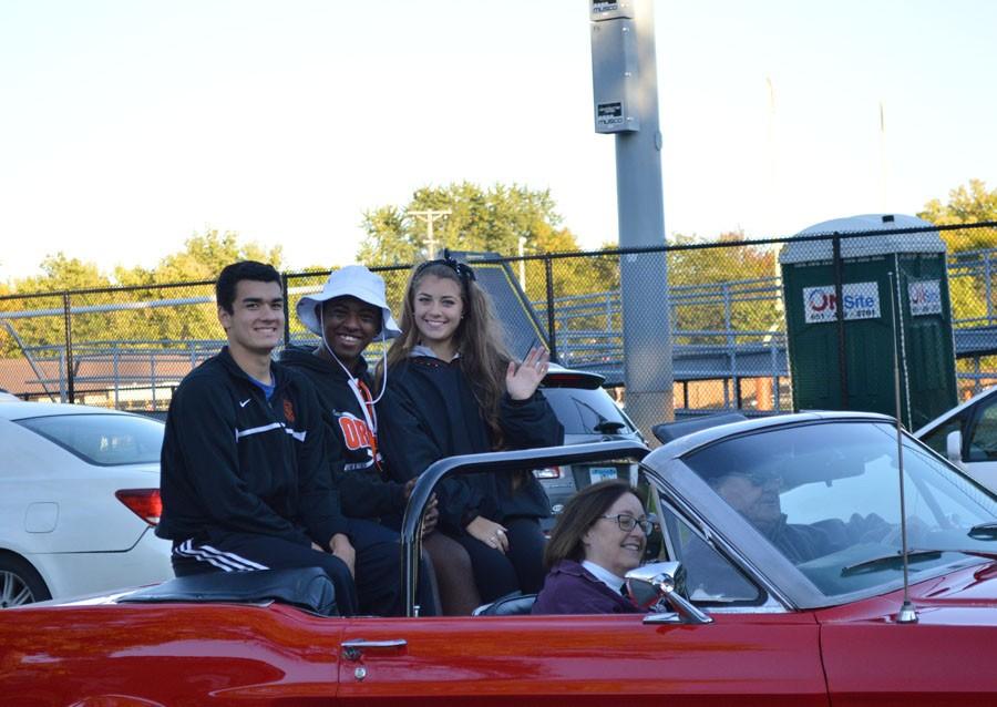Homecoming royalty wave at tailgaters as they participate in the homecoming parade. 