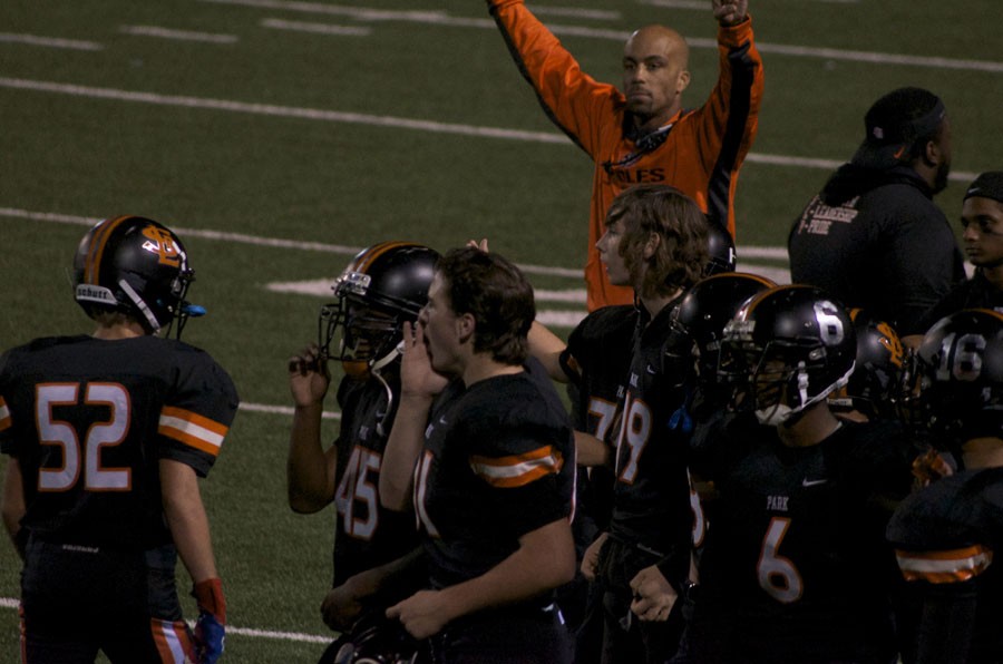 Football team cheers after scoring second touchdown of homecoming football game.