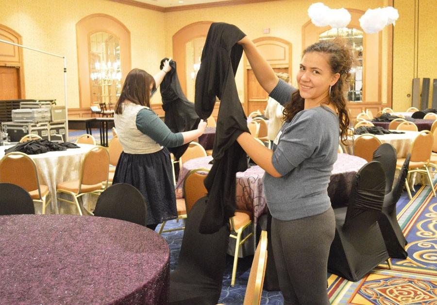 Senior Danny Campos helps assemble seat covers in preparation for Park Nicollets Silver Linings Gala. 