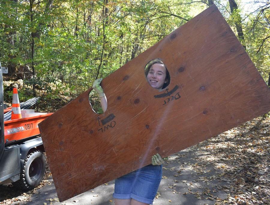 Senior, Tess McQuillan helps transport supplies for the Westwood Nature Centers annual Halloween party.