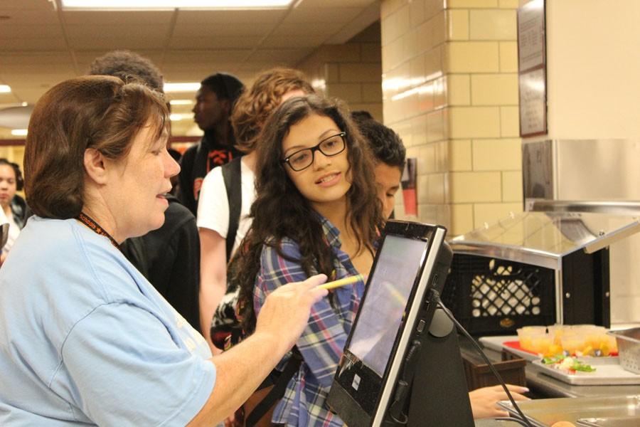 Cristi Beightol works at the checkout line during lunch Sept. 17. along with all the other nutritional services staff, Beightol said she enjoys the daily interaction with students in the cafeteria. I most enjoy meeting different students and getting to know them, she said.
