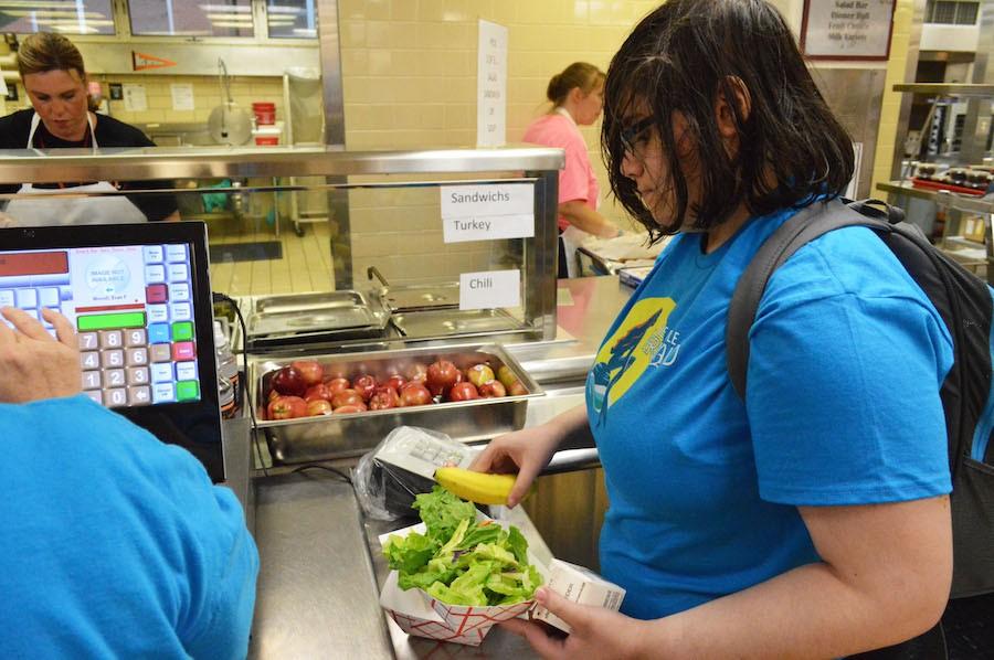 Sophomore Ellie Okan purchases her lunch from the lunch line, which offers healthy alternatives through a salad bar.