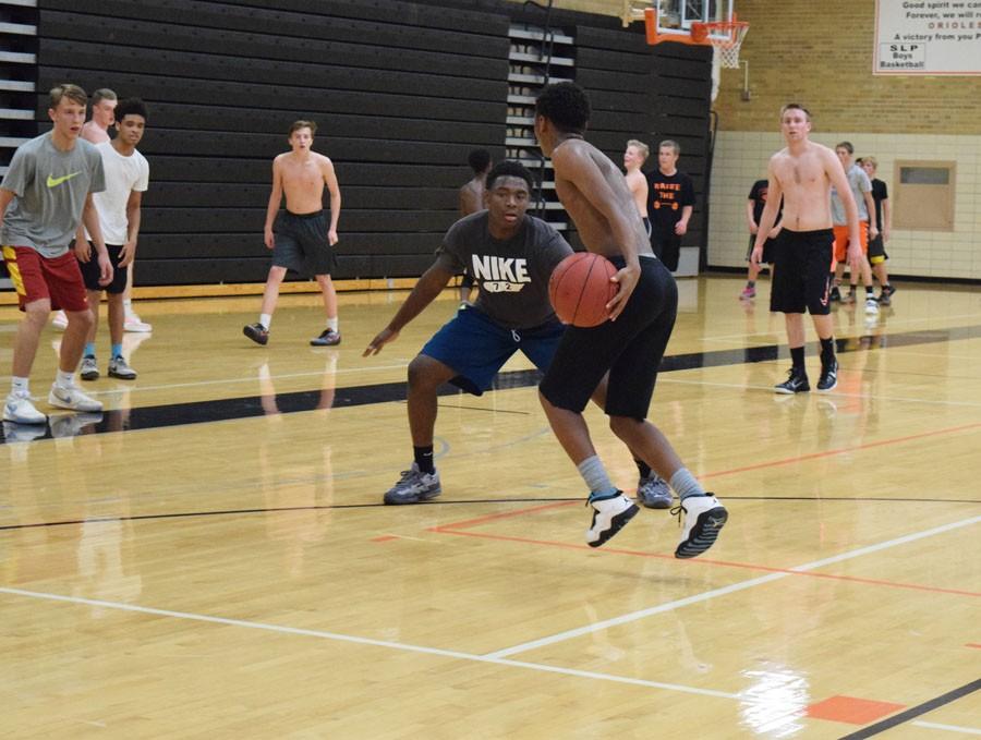 Sophomore Cire Mayfield dribbles towards junior Josiah Morrow during open gym on Nov. 2.