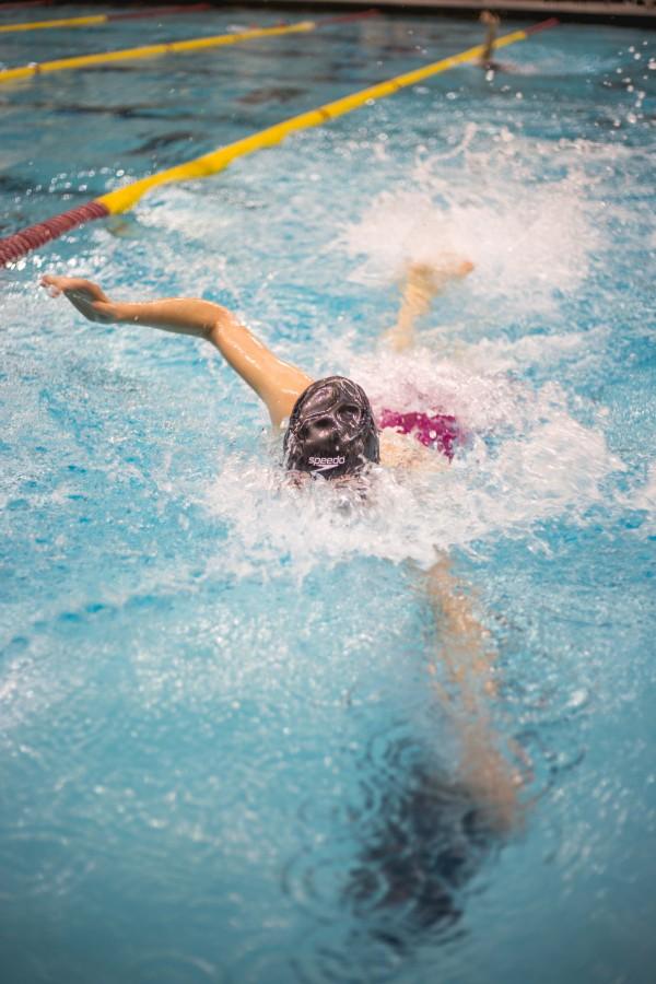 Junior Kailey DeLozier in the warm up pool, just before her event at the girls high school swimming state championship  