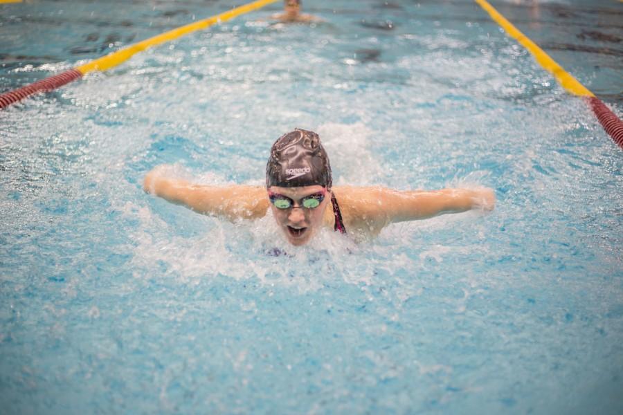 Junior Kailey DeLozier takes a lap in the warm up pool just before her event at the girls swimming state championship Nov. 20 at the University of Minnesota Aquatic Center.