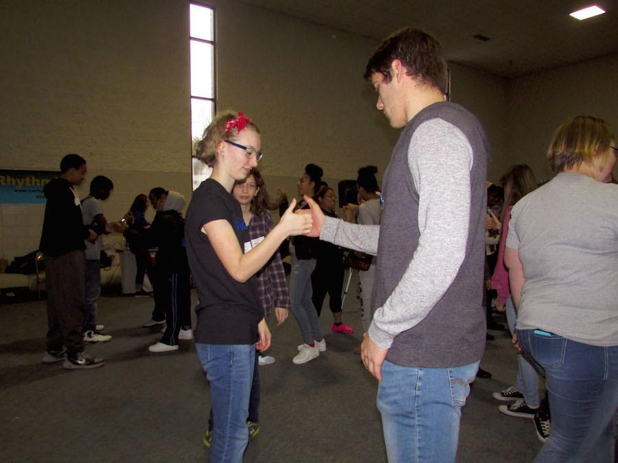 Freshman Jo Bruse and Junior Ryan Domres thumb war and get to know each other at the Freshman Respect Retreat.