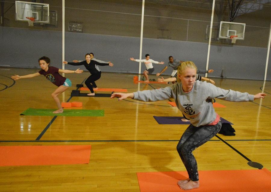 Sophomore Savannah Kjaer holds a pose in Jessica Gust’s Friday morning yoga class Nov. 20.