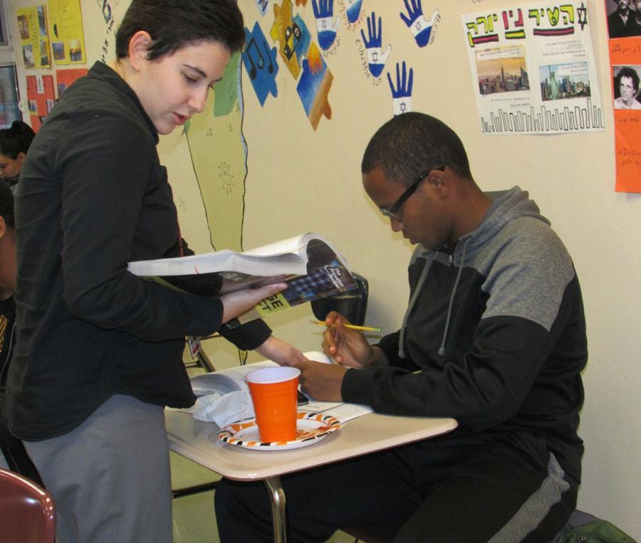 Junior Mohamed Aideed seeks help with his ACT prep work from College Possible coach Rana Haroun.