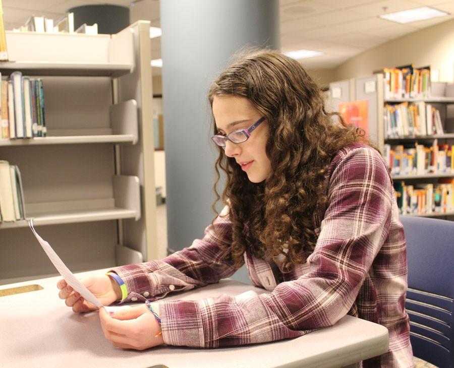 Sophomore Chava Buchbinder prepares for the poetry slam Dec. 7 in the Media Center by reviewing her poetry.