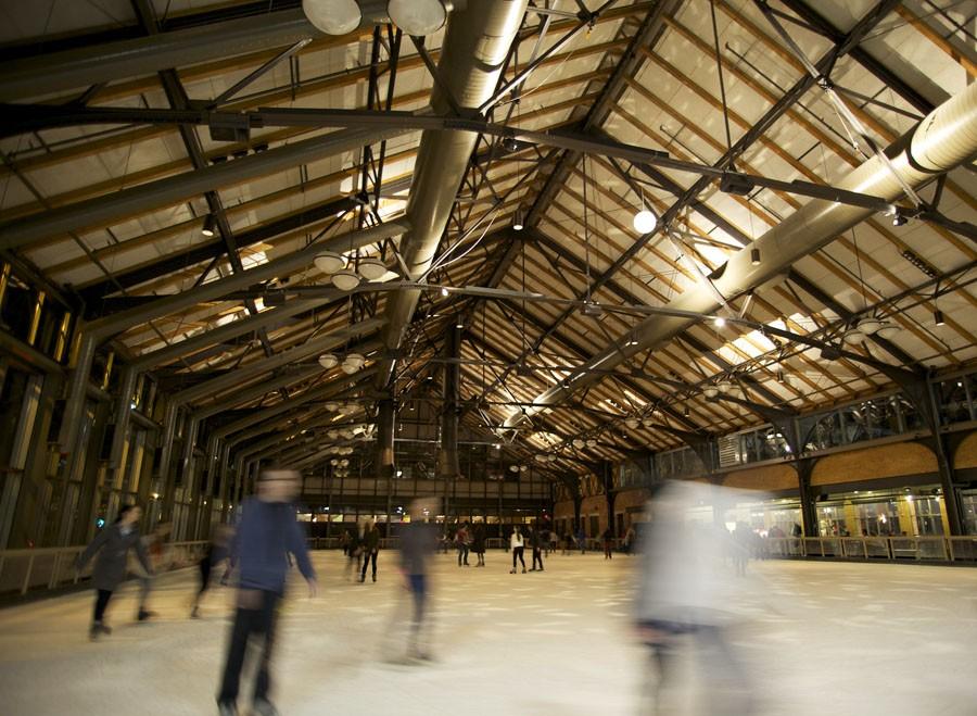 People skate around the oval shaped ice rink, The Depot, under a disco ball to add to the fun.
