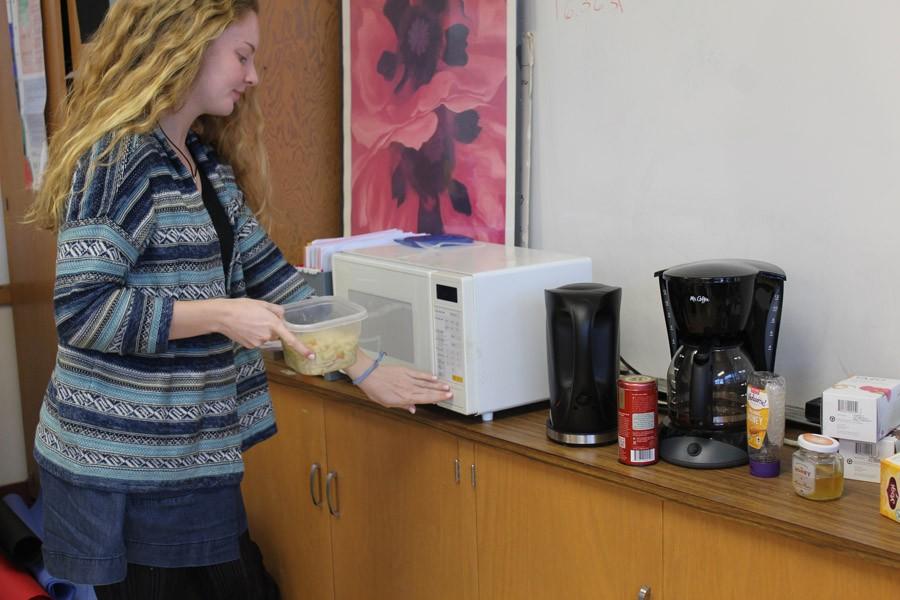 Senior Kelli Cook takes advantage of the microwave in Julianne Herberts class. Cook and other staffers use the microwave to heat snacks and lunch items.
