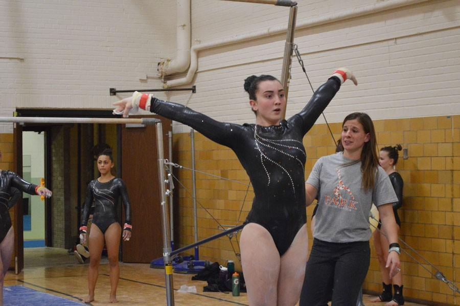 Junior Audrey Scalici hits her last pose during the uneven bars event at her first gymnastics meet Dec. 1. 