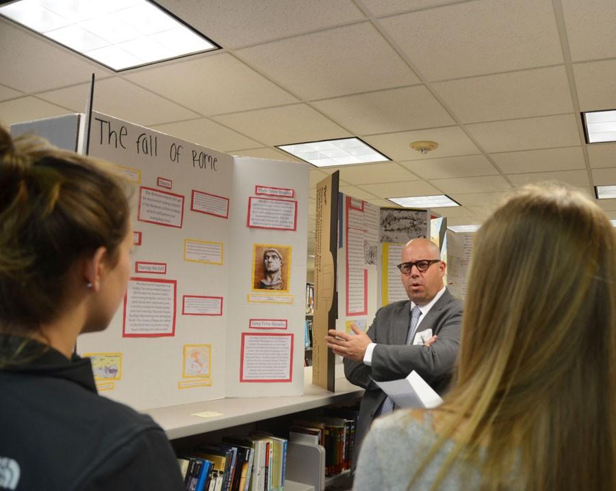 Mayor and History day Judge Jake Spano asks Sophomores Katelyn Lanoux and Annie Van Pilsum-Johnson questions about their History Day project.