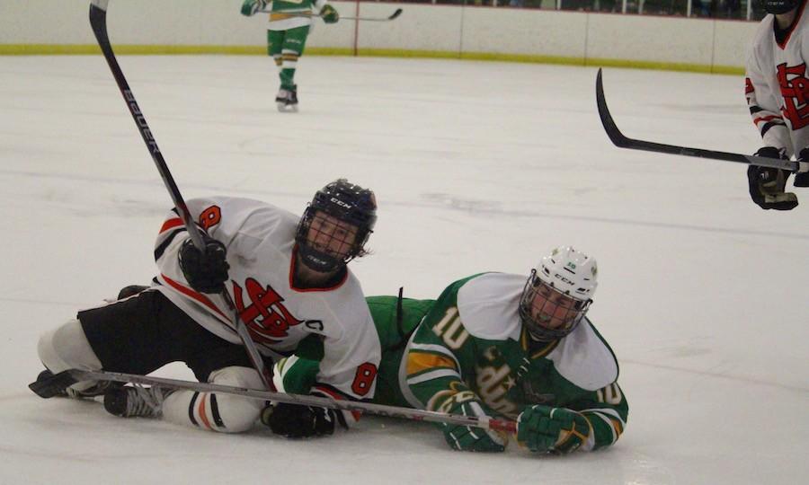 After colliding with Edina forward Sam Walker, junior Bauer Neudecker quickly gets up to defend the puck.