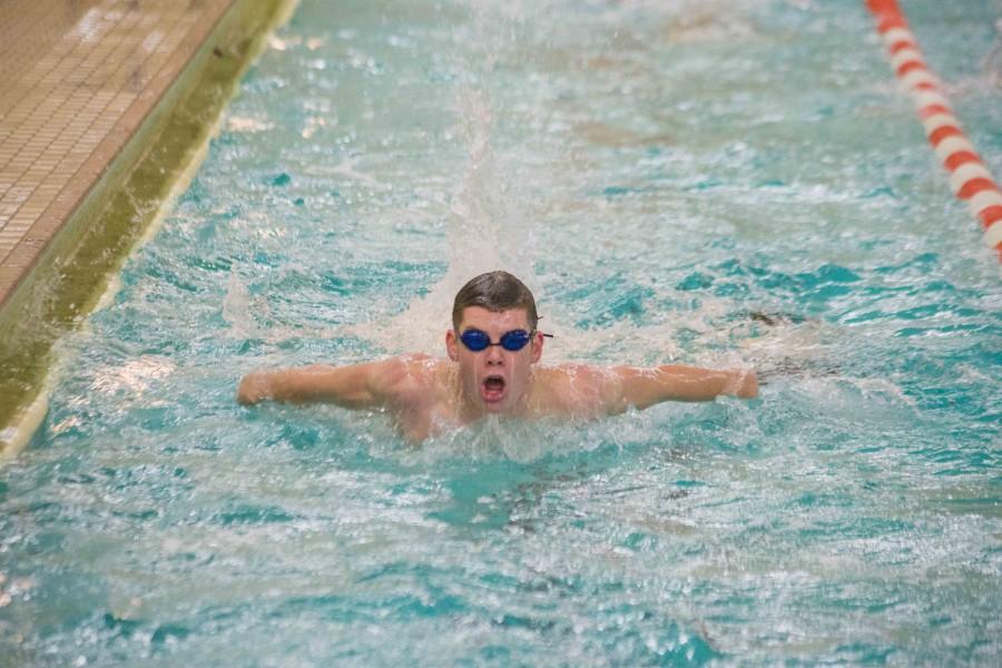 Senior Ryan Casey finishes a lap during a warmup at his home pool during practice on Dec. 3