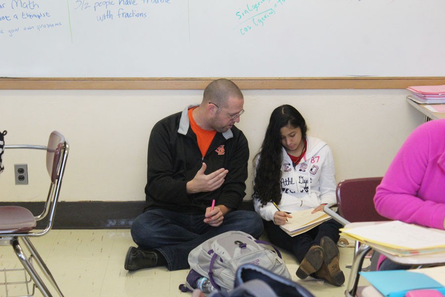 Math teacher Chad Austad works with sophomore Sabrina Garcia during class.