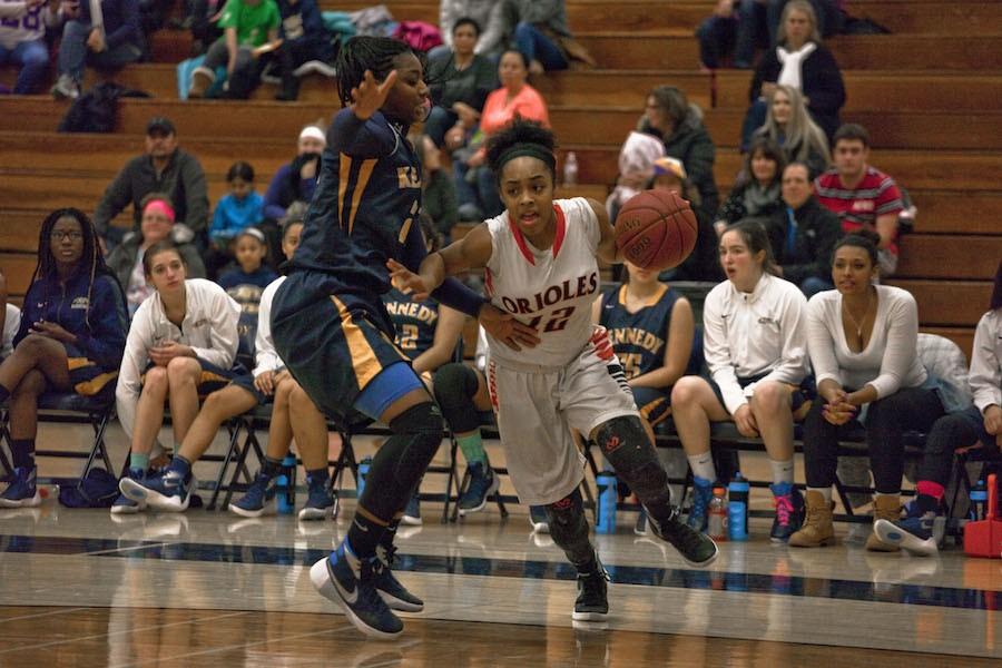 Sophomore Tejah Marie plays around the Bloomington Kennedy defender attempting to score Jan. 8