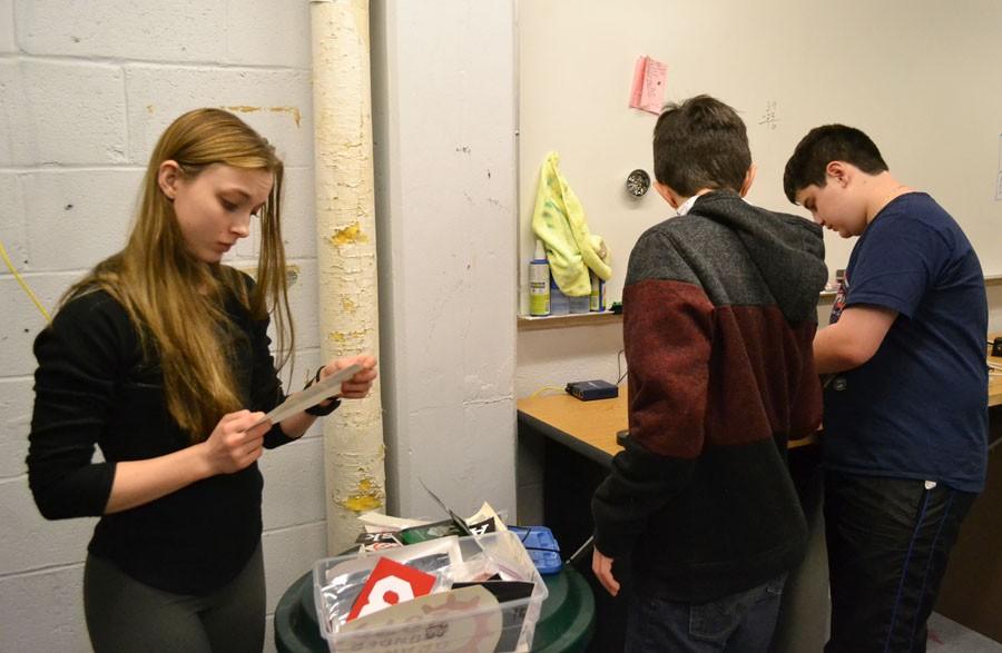 Senior robotics captain Clara Slade and freshmen Alessandro Giannetti and Anthony David work on cleaning their workshop Jan. 6. The clubs kickoff took place Jan. 9, giving the members six weeks to build their robot.