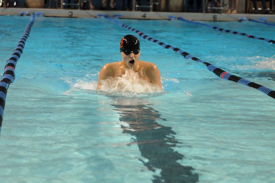 Junior captain Nate Stone competes in the 200 yard individual medley during the boys meet against Hopkins on Tuesday, Dec. 15. Stone won the event with a time of 2:06.18, out-touching Hopkins swimmer Avery Martens-Goldman.
