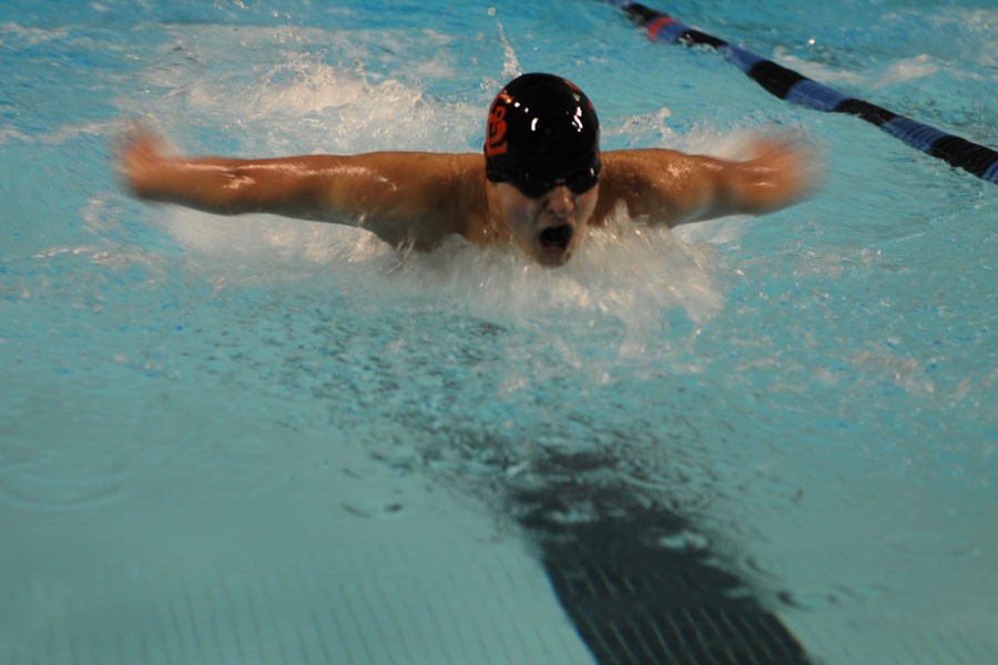Junior captain Nate Stone competes in the 100 yard butterfly against Hopkins at Hopkins High School on Tuesday, Dec. 15. Stone won the event with a time of 56.82.
