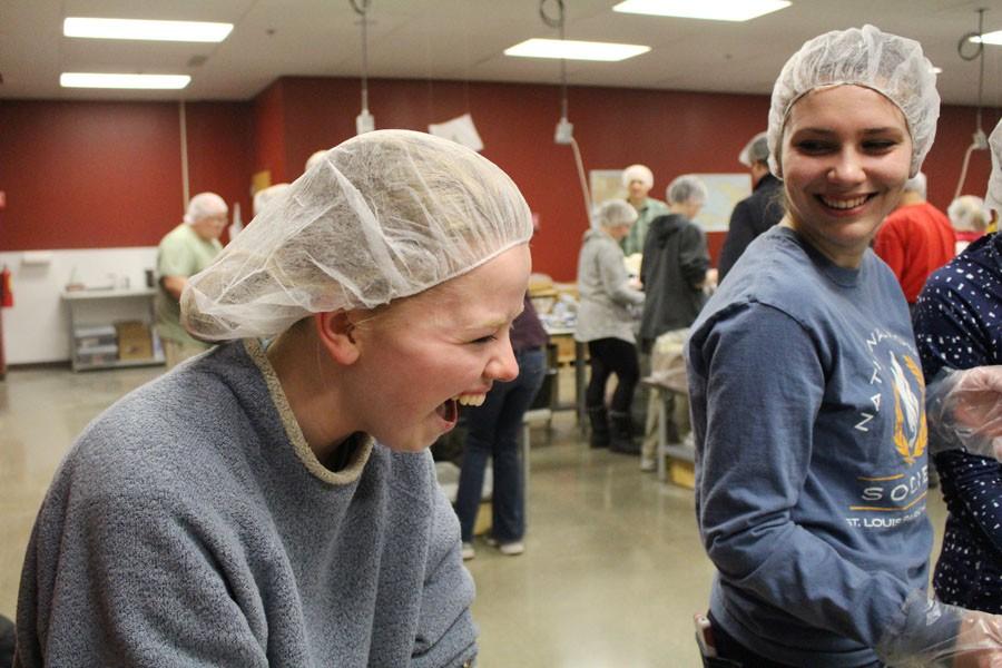 Seniors Annika Johnson and Kala Jennissen volunteer at Feed My Starving Children on Feb. 4 for an NHS group project. 
