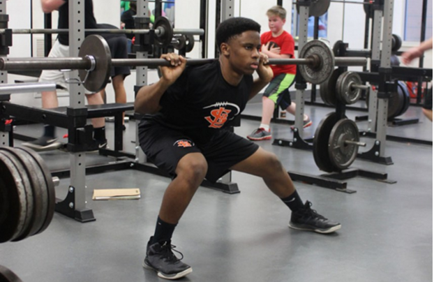 Sophomore Aaron Sledge performs a side lunge while participating in strength and conditioning practice after school Jan. 11. To apply for the High Flyers program, speak to Jessica Gust in room A302.