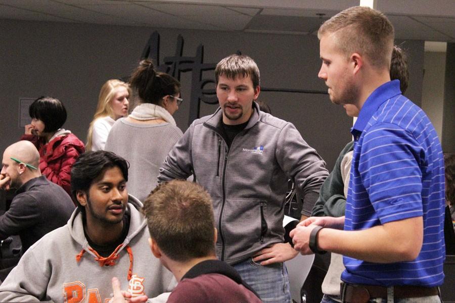 Senior Jerry  Somaiah discusses a future project with his mentors at the ACE meeting Feb. 4.
