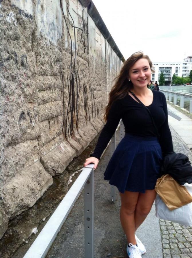 Junior Kim Brandt stands next to a segment of the Berlin Wall during her trip to Germany in the summer of 2015.