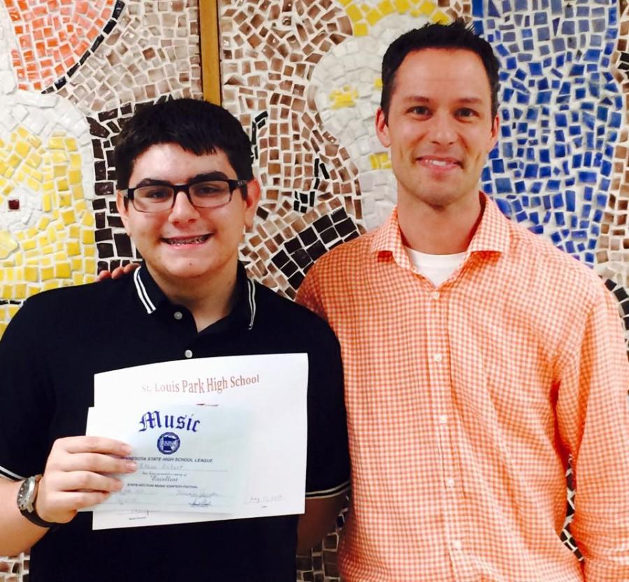 Sophomore Ethan Rickert receives his letter certificate from band director Steve Schmitz May 14, 2015.