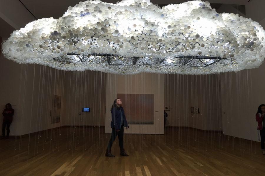 Senior Grace Pelowitz examines the interactive cloud art installation March 23 at the Weisman Art Museum. The exhibit Clouds, Temporarily Visible runs until May 22.